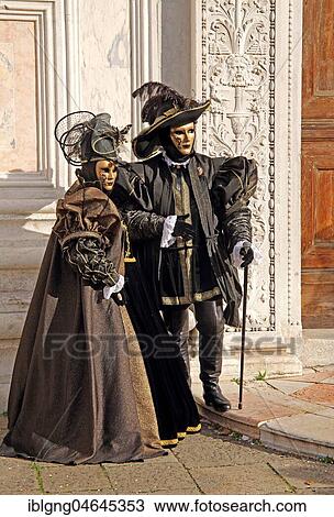 Stock Image - Disguised couple with Venetian masks, carnival in Venice, Italy, Europe. Fotosearch
