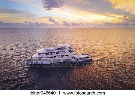 Diving safari ship MS Keana with diving dhoni anchored at sunset, Ari Atoll, Indian Ocean, Maldives, Asia View Large Photo Image Stock Image - Diving safari ship MS Keana with diving dhoni anchored at sunset, Ari Atoll, Indian Ocean, Maldives, Asia. Fotosearch