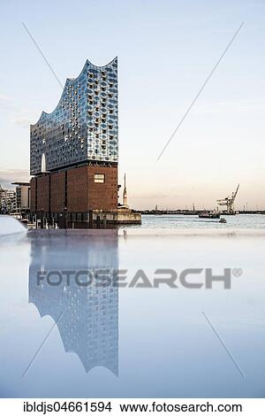Picture - Elbe Philharmonic Hall in the evening light with water reflection, architects Herzog & De Meuron, Hafencity, Hamburg, Germany, Europe. Fotosearch
