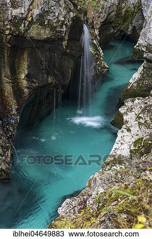 Stock Image - Emerald green wild river Soca flows through rocky gorge, Socatal, Slovenia, Europe. Fotosearch