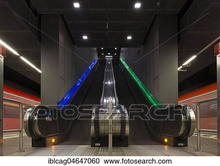 Stock Image - Escalators at the platform, Taunusanlage subway station with arriving subway trains, Westend, Frankfurt am Main, Hesse, Germany, Europe. Fotosearch