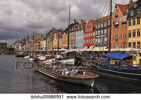 Stock Image - Excursion boat at the busy Nyhavn Canal, amusement district, Copenhagen, Denmark, Europe. Fotosearch