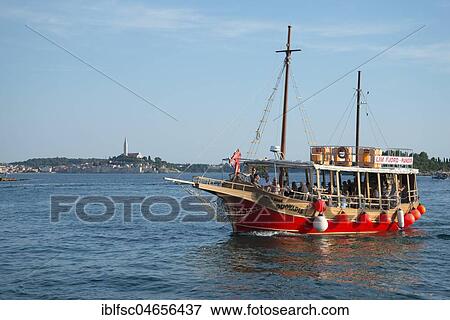 Excursion boat, in the back town Rovinj, Istria, Croatia, Europe View Large Photo Image Stock Photo - Excursion boat, in the back town Rovinj, Istria, Croatia, Europe. Fotosearch