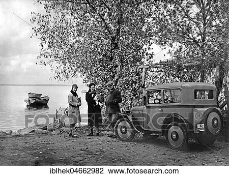 Stock Image - Family trip by car to the lake, 1930s, Germany, Europe. Fotosearch