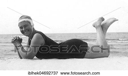 Fashion, swimwear, woman lying on the beach with swimsuit and bathing cap, 1930s, Rügen, Germany, Europe View Large Photo Image Stock Photo - Fashion, swimwear, woman lying on the beach with swimsuit and bathing cap, 1930s, Rügen, Germany, Europe. Fotosearch