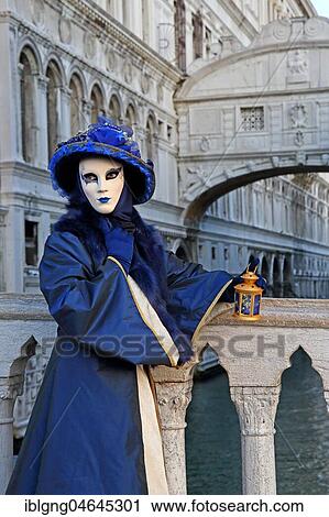 Stock Image - Female disguised with Venetian mask in front of Bridge of Sighs, Carnival in Venice, Italy, Europe. Fotosearch