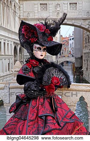 Stock Photo - Female disguised with Venetian mask in front of Bridge of Sighs, Carnival in Venice, Italy, Europe. Fotosearch
