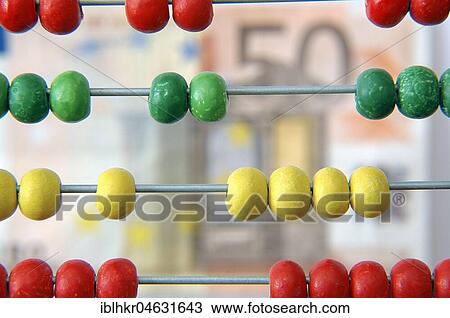 Stock Image - Fifty euro note behind an abacus, symbol picture for financing. Fotosearch