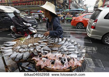 Fish Street Sales, Fish Saleswoman in dense traffic, Yaowarat Road, Chinatown, Samphanthawong, Bangkok, Thailand, Asia View Large Photo Image Stock Photo - Fish Street Sales, Fish Saleswoman in dense traffic, Yaowarat Road, Chinatown, Samphanthawong, Bangkok, Thailand, Asia. Fotosearch
