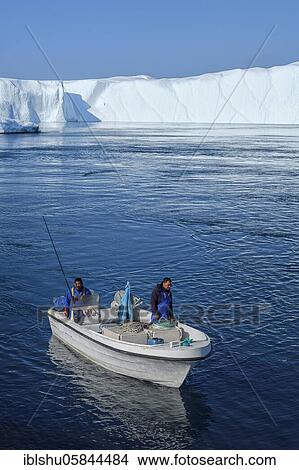 Picture - Fishermen with boat in front of gigantic icebergs, UNESCO World Natural Heritage, Ilulissat, Disko Bay, West Greenland, Greenland, North America. Fotosearch