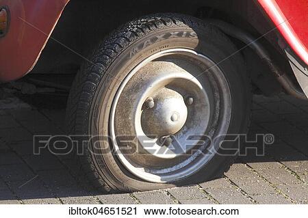 Stock Image - Flat tire on vintage car, Citroen 2CV Ente, Germany, Europe. Fotosearch