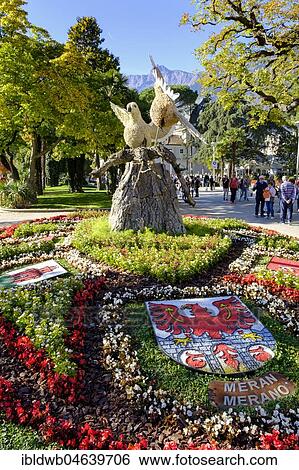 Stock Photograph - Flowerbed with coat of arms on the promenade, Merano, South Tyrol, Italy, Europe. Fotosearch