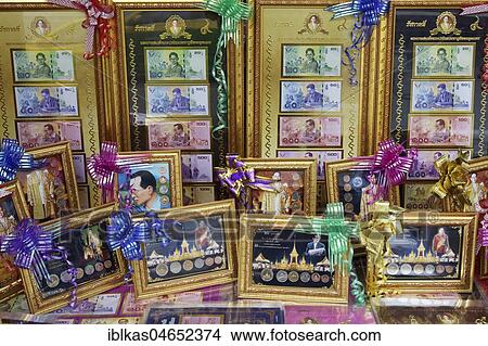 Picture - Former King Bhumibol Adulyadej on banknotes and coins, souvenirs in gold frame, Bangkok, Thailand, Asia. Fotosearch