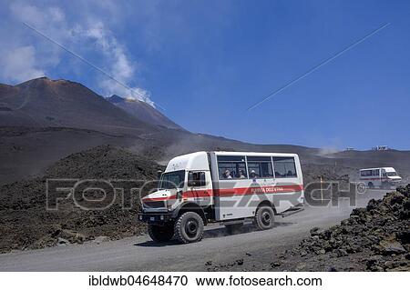 Stock Image - Four-wheel drive vehicles on gravel road to Etna volcano, province of Catania, Silzilia, Italy, Europe. Fotosearch