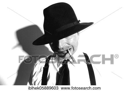 Stock Image - Gangster with hat and cigarette, Berlin, Germany, Europe. Fotosearch
