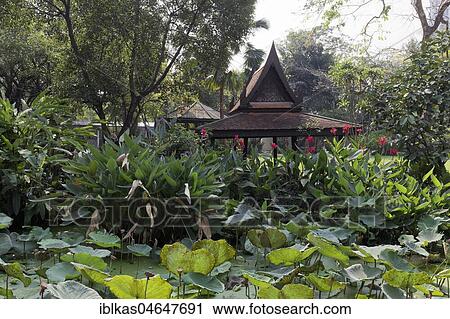 Stock Image - Garden with Thai wooden pavilion, M. R. Kukrit's House, Museum, Sathorn, Bangkok, Thailand, Asia. Fotosearch