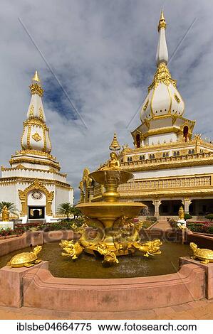 Stock Photography - Gilded fountain in front of the 101m high Phra Maha Chedi Chai Mongkhon Pagoda, Wat Pha Nam Yoi Temple, Phuttha-Utthayan Park, Province Roi Et, Isan, Northeast, Thailand, Asia. Fotosearch