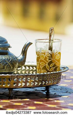 Stock Photo - Glas mit Minztee und silberne Teekanne, Marokko, Afrika. Fotosearch