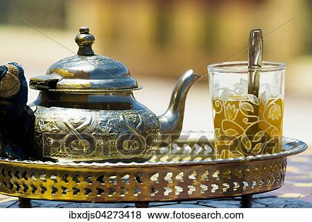 Stock Photo - Glas mit Minztee und silberne Teekanne, Marokko, Afrika. Fotosearch