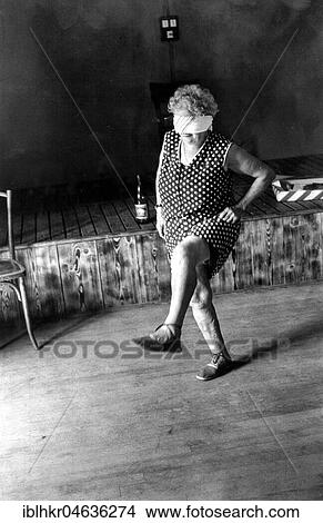 Picture - Grandma dances with blindfolded eyes, ca. 1970s, exact place unknown, France, Europe. Fotosearch