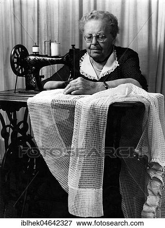 Stock Photo - Grandma sewing, 1950s, Germany, Europe. Fotosearch