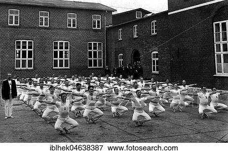 Stock Photo - Group of men in the yard during their morning sports, 1930s, exact place unknown, Germany, Europe. Fotosearch