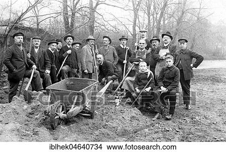 Picture - Group picture, construction workers with sand heap and spades, 1930s, exact location unknown, Germany, Europe. Fotosearch