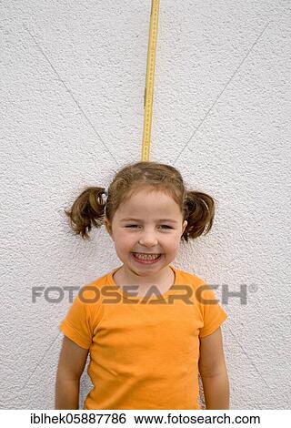 Stock Photograph - Grown, girl is measured, laughs, Lauda, Germany, Europe. Fotosearch