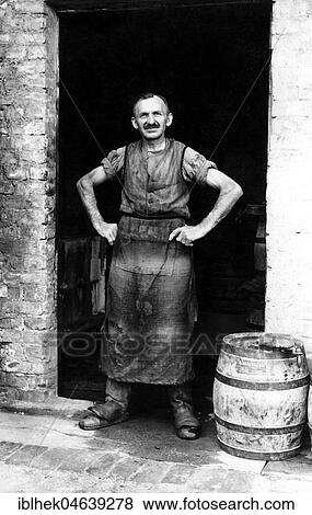 Handicraft, barrel maker stands in the door of his workshop, 1930s, exact place unknown, Germany, Europe View Large Photo Image Stock Photo - Handicraft, barrel maker stands in the door of his workshop, 1930s, exact place unknown, Germany, Europe. Fotosearch
