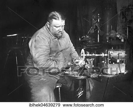 Stock Photo - Handicraft, fat man working on a grinding machine, ca. 1930s, exact place unknown, Germany, Europe. Fotosearch