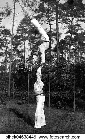 Stock Photography - Handstand on the hands of another, ca. 1937, 1930s, exact place unknown, Germany, Europe. Fotosearch