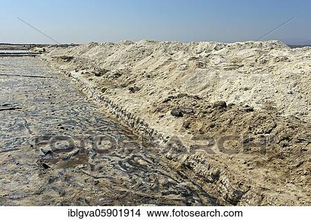 Picture - Harvested rock salt at the edge of an evaporation basin of a salt works, commercial salt production on the Assale Salt Lake near Hamadela, Danakil Depression, Afar Region, Ethiopia, Africa. Fotosearch