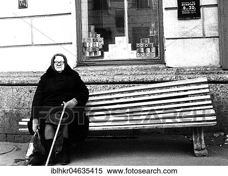 Stock Photography - Heavy grandmother sits on the bench, between 50s and 60s, exact location unknown, France, Europe. Fotosearch