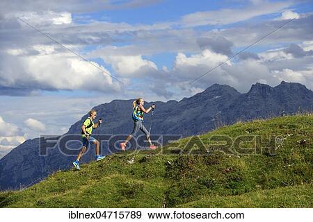 Stock Photo - Hiker on the Eggenalm, behind Loferer Steinberge, Reit im Winkl, Upper Bavaria, Bavaria, Germany, Europe. Fotosearch