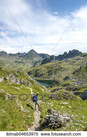 Stock Photography - Hikers at Brettersee, Schladminger Höhenweg, Schladminger Tauern, Schladming, Styria, Austria, Europe. Fotosearch