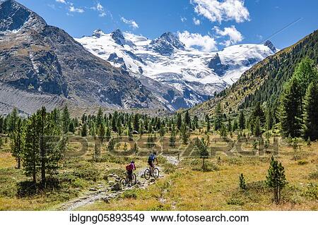 Stock Photo - Hiking trail and mountain biking in the Roseg Valley, Val Roseg with Piz Glüschaint and Roseg Glacier, Pontresina, Bernina Alps, Upper Engadine, Engadine, Grisons, Switzerland, Europe. Fotosearch