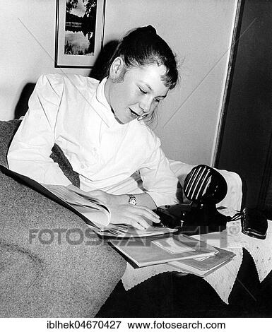 Stock Photo - History of technology, woman speaks into an intercom, 1950s, Germany, Europe. Fotosearch