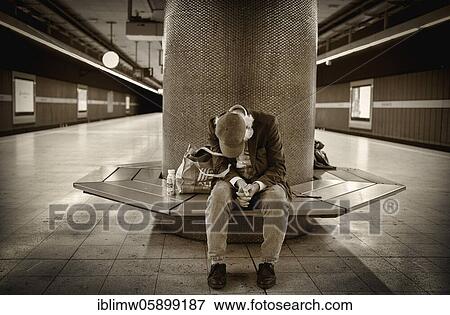 Homeless person, Berber, sitting in the waiting area of a suburban railway station, Stuttgart, Baden-Württemberg, Germany, Europe View Large Photo Image Stock Photo - Homeless person, Berber, sitting in the waiting area of a suburban railway station, Stuttgart, Baden-Württemberg, Germany, Europe. Fotosearch