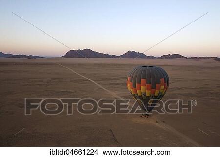 Hot-air balloon is ready for take-off, at dawn, aerial view, Kulala Wilderness Reserve, Namib Desert, Namibia, Africa View Large Photo Image Picture - Hot-air balloon is ready for take-off, at dawn, aerial view, Kulala Wilderness Reserve, Namib Desert, Namibia, Africa. Fotosearch