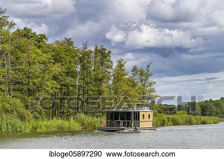 Houseboat on the Peene River, Peene Valley nature park Park, Mecklenburg-Western Pomerania, Germany, Europe View Large Photo Image Stock Image - Houseboat on the Peene River, Peene Valley nature park Park, Mecklenburg-Western Pomerania, Germany, Europe. Fotosearch