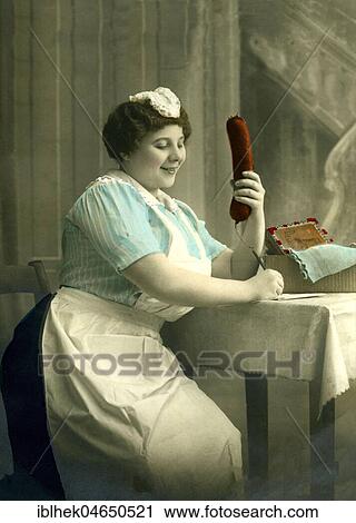 Housekeeper writes a letter with a big sausage in her hand, 1920s, Germany, Europe View Large Photo Image Stock Image - Housekeeper writes a letter with a big sausage in her hand, 1920s, Germany, Europe. Fotosearch