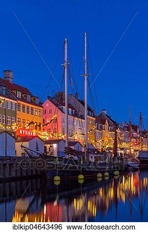Stock Photograph - Houses at Nyhavn waterfront with Christmas decorations at dawn, Nyhavn, Copenhagen, Denmark, Europe. Fotosearch