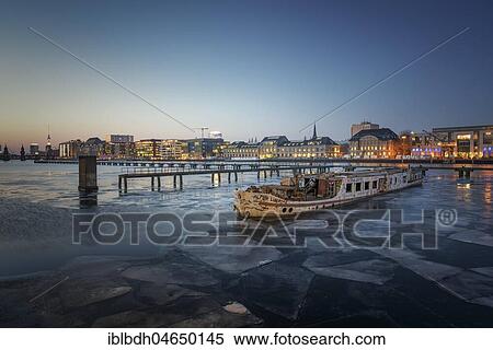 Stock Photography - Ice floes in the river Spree between Elsenbrücke and Oberbaum Bridge during blue hour, Berlin, Germany, Europe. Fotosearch