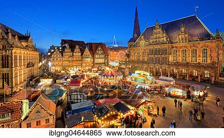 Stock Photography - Illuminated Christmas market on the town hall square, in front of town houses, tower of the Liebfrauenkirche and town hall, evening twilight, Bremen, Germany, Europe. Fotosearch