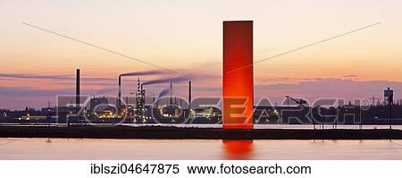 Stock Photography - Illuminated sculpture Rheinorange in the sunset in front of industrial panorama, Rhine, Duisburg, Ruhr Area, North Rhine-Westphalia, Germany, Europe. Fotosearch