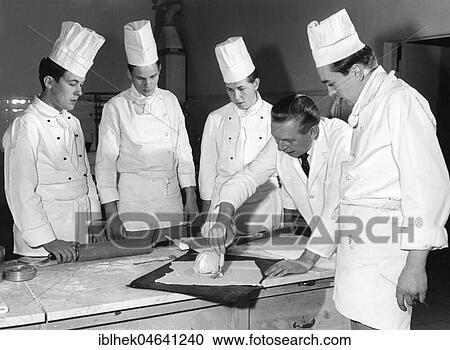 Stock Image - Instructor introduces apprentices to baking, 1960s, Berlin, Germany, Europe. Fotosearch