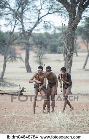 Kung Bushmen are following an animal trail, Zebra Lodge, Hardap Region, Namibia! View Large Photo Image Picture - Kung Bushmen are following an animal trail, Zebra Lodge, Hardap Region, Namibia!. Fotosearch