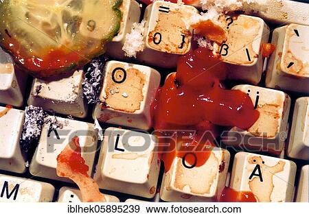 Stock Photo - Leftovers and ashes on the keyboard, disgusting, ketchup, cucumber, Berlin, Germany, Europe. Fotosearch