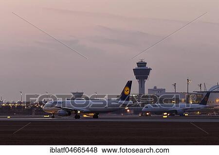 Lufthansa A321-100, takeoff on the south runway, dusk, tower and terminal 2 in the back, Munich Airport, Upper Bavaria, Germany, Europe View Large Photo Image Stock Photo - Lufthansa A321-100, takeoff on the south runway, dusk, tower and terminal 2 in the back, Munich Airport, Upper Bavaria, Germany, Europe. Fotosearch