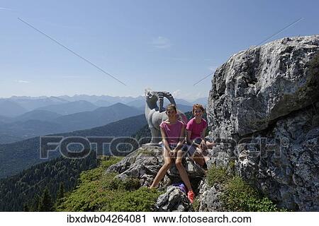 Stock Image - Madchen, Teenager rasten bei der Stie-Alm, Brauneck, bei Lenggries, Isarwinkel, Oberbayern, Bayern, Deutschland, Europa. Fotosearch
